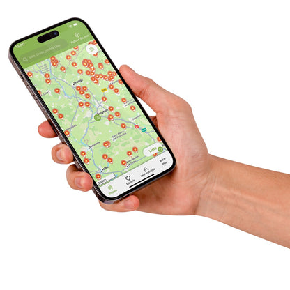 Hand holding a smartphone displaying a map with markers showing France Passion locations